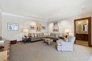 Living room featuring ornamental molding, light colored carpet, wallpapered walls, and recessed lighting