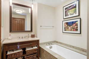 Bathroom with a bath and vanity