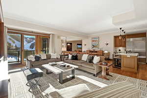 Living area featuring crown molding and wood finished floors