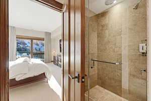 Full bathroom featuring connected bathroom, a stall shower, and carpet floors