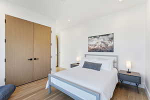 Bedroom featuring a closet, recessed lighting, and light wood-type flooring