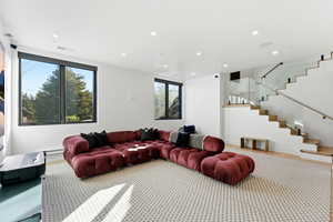 Living room with stairs and recessed lighting