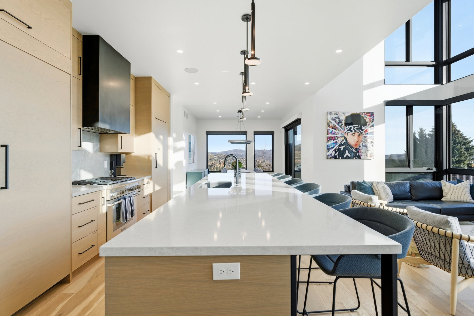 Kitchen featuring modern cabinets, light brown cabinetry, a kitchen bar, a spacious island, and recessed lighting