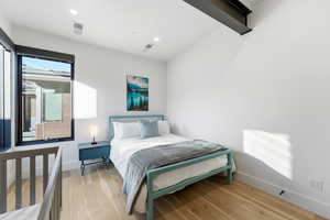 Bedroom with light wood finished floors and recessed lighting