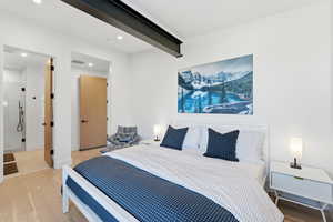 Bedroom with wood finished floors, recessed lighting, and beam ceiling