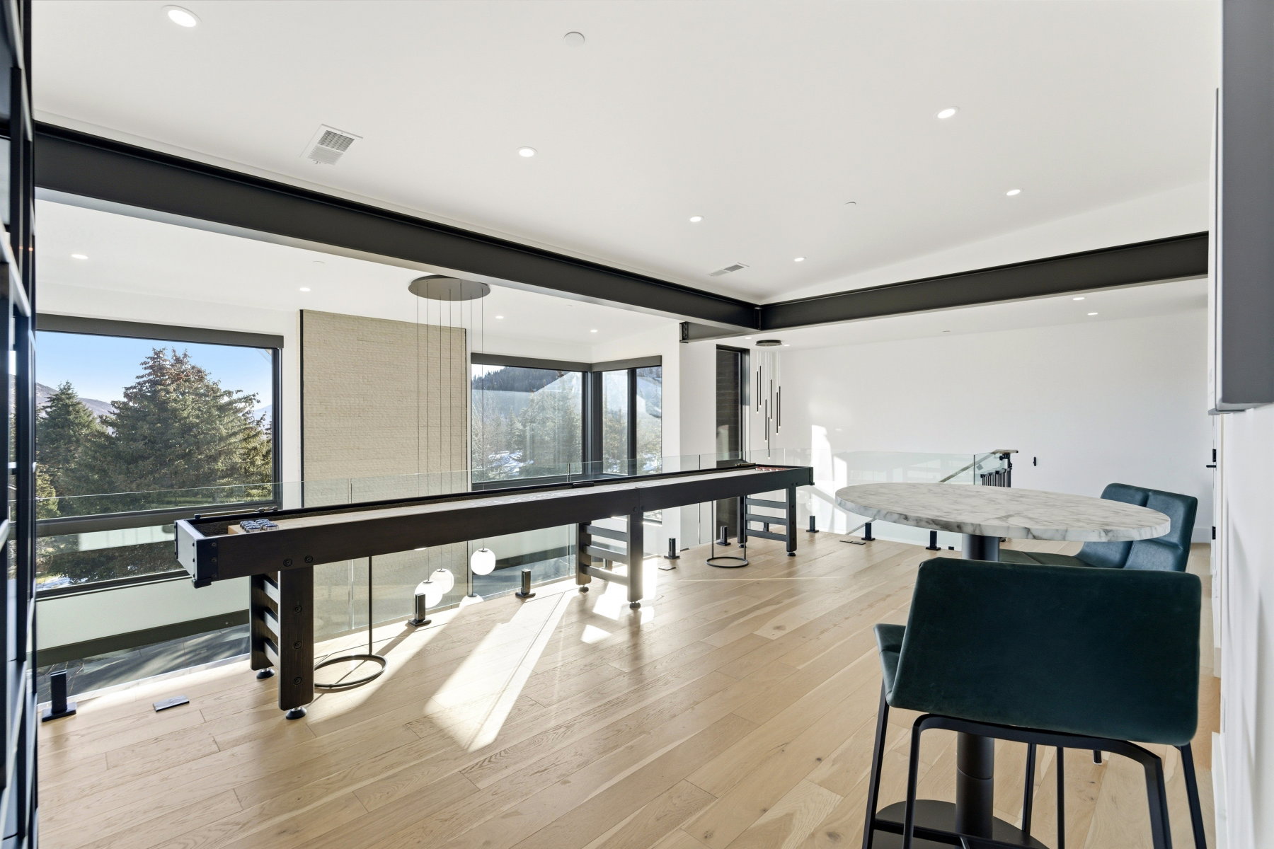 Game room with light wood-style flooring, plenty of natural light, and recessed lighting