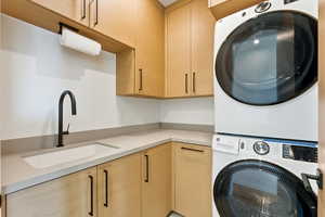 Laundry area with cabinet space and stacked washer / drying machine