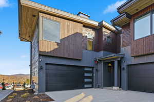 Modern home featuring a garage and driveway