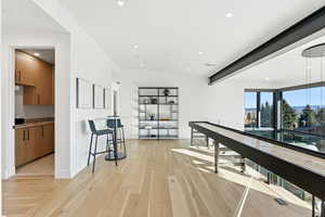 Corridor featuring light wood-type flooring and recessed lighting