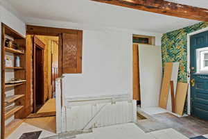 Unfurnished room with wallpapered walls