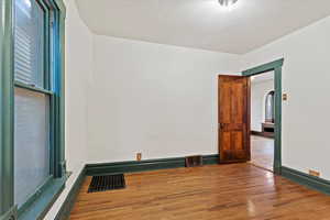 Empty room with wood finished floors and arched walkways