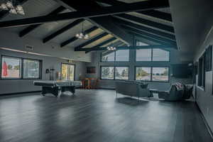 Rec room with high vaulted ceiling, a chandelier, beamed ceiling, and pool table