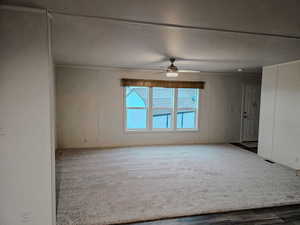 Empty room with carpet flooring and ceiling fan