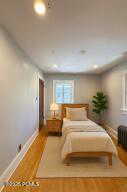 Bedroom featuring wood finished floors and recessed lighting. Smallest bedroom.
