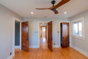 Unfurnished bedroom with a ceiling fan, light wood-style floors, and recessed lighting