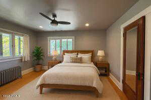 Bedroom featuring radiator, ceiling fan, recessed lighting, and wood finished floors