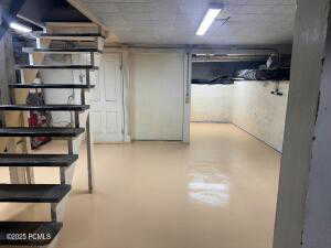 View of partially finished below grade area. Lots of storage and there is an exterior entrance.