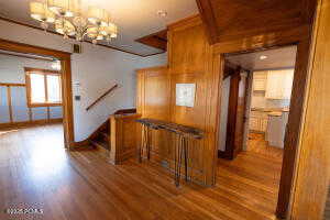 Hall featuring dark wood-style floors