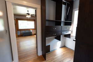 Closet featuring radiator heating unit