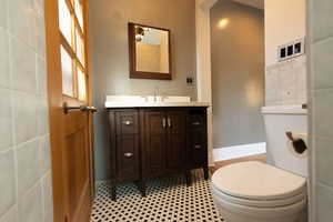 Bathroom with vanity and baseboards