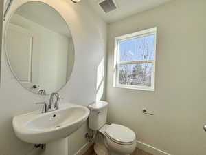 Bathroom with toilet and baseboards