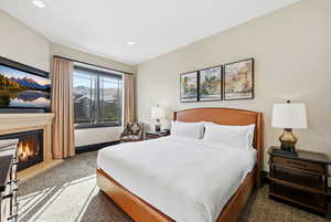 Primary suite with king bed, ski resort views and fireplace.