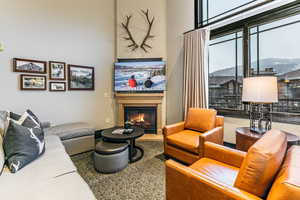 Great Room with ski resort views, vaulted ceilings, fireplace, and private balcony.