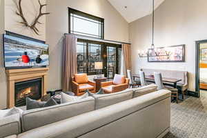 Great Room with ski resort views, vaulted ceilings, fireplace, and private balcony.