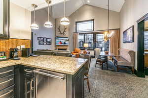 Great Room with ski resort views, vaulted ceilings, fireplace, and private balcony.