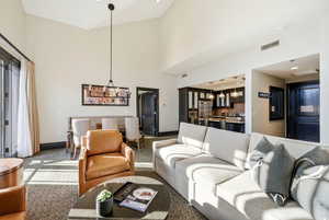 Great Room with ski resort views, vaulted ceilings, fireplace, and private balcony.