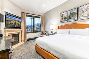 Primary suite with king bed, ski resort views and fireplace.