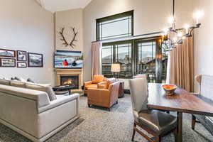 Great Room with ski resort views, vaulted ceilings, fireplace, and private balcony.
