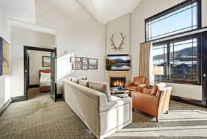 Great Room with ski resort views, vaulted ceilings, fireplace, and private balcony.