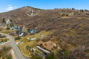 Aerial view of property and surrounding area featuring mountains