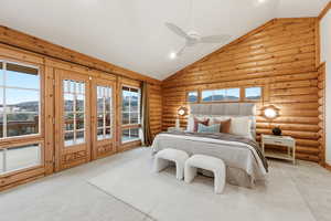 Carpeted bedroom with rustic walls, access to outside, ceiling fan, high vaulted ceiling, and a mountain view