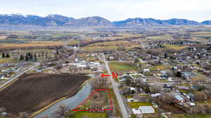 Aerial view of property and surrounding area with property boundaries highlighted and mountains