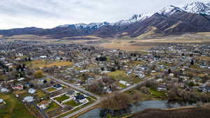 Aerial view of property's location with mountains and nearby suburban area