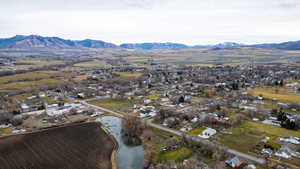 Aerial view of property and surrounding area featuring a water and mountain view