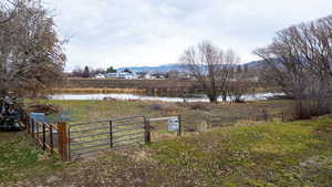 View of yard featuring a gate and a water and mountain view