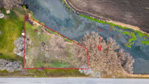 Aerial overview of property's location featuring a nearby body of water and property parcel outlined