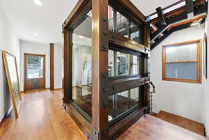 Corridor featuring hardwood / wood-style floors and recessed lighting