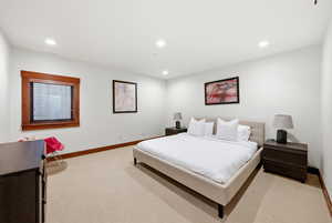Bedroom with light carpet and recessed lighting