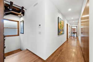 Hallway featuring wood-type flooring and recessed lighting