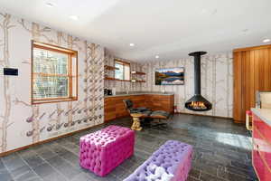 Game room featuring wallpapered walls, a wood stove, and recessed lighting