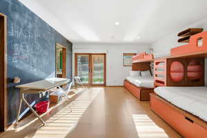 Bedroom with access to outside, recessed lighting, and light flooring