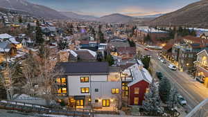Aerial view of property and surrounding area with mountains