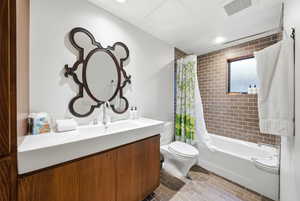 Bathroom with shower / bath combination with curtain, vanity, and recessed lighting
