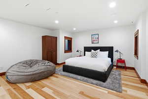 Bedroom with recessed lighting and light wood-style floors
