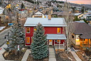 View of front of home with a metal roof, a standing seam roof, a porch, and a residential view
