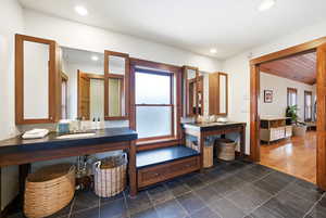 Bathroom with vanity and dark tile patterned flooring